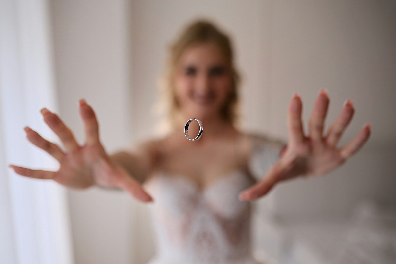 Bride tossing a wedding ring in the air