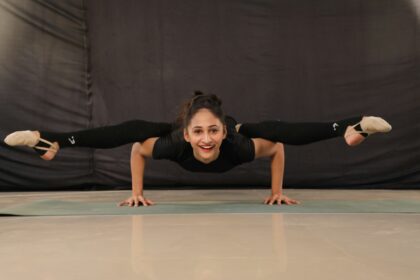 woman in black t-shirt and black pants doing yoga