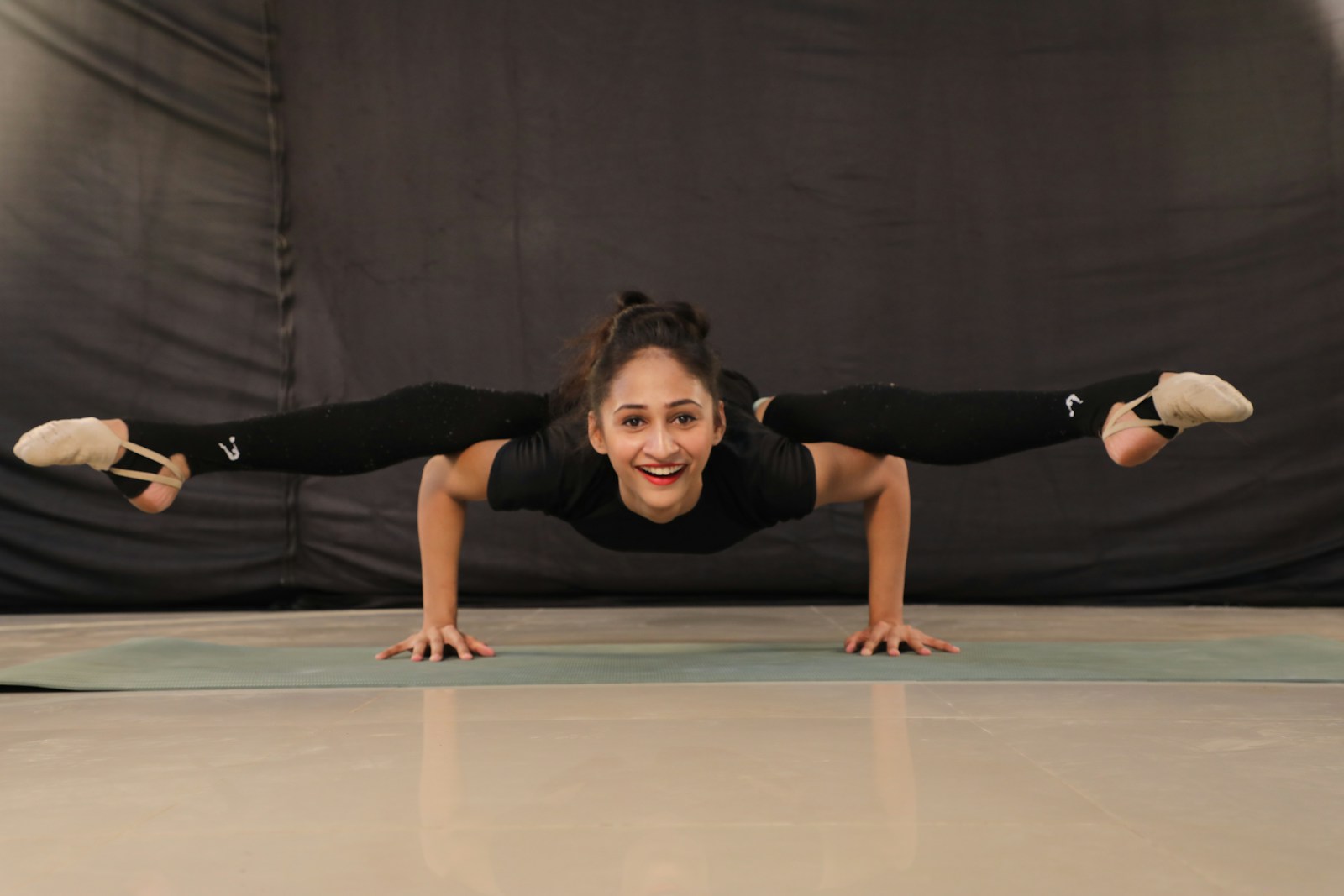 woman in black t-shirt and black pants doing yoga
