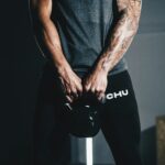 man in black tank top and black pants